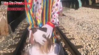 clown almost gets hit by train while getting head